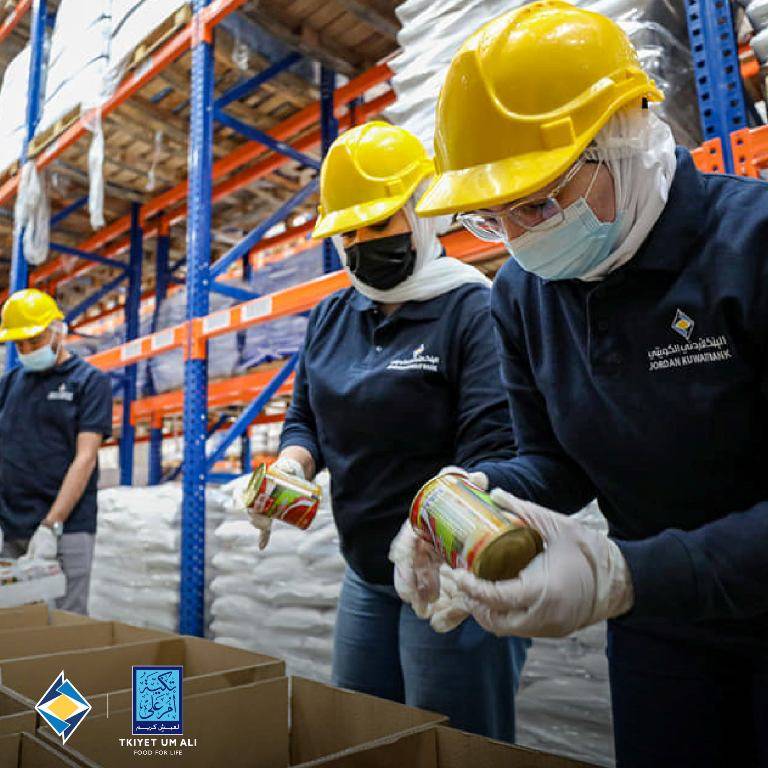 موظفو البنك الاردني الكويتي يشاركون في تعبئة وتوزيع طرود الخير على الاسر العفيفة